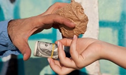 Two Hands interchanging money and a bag